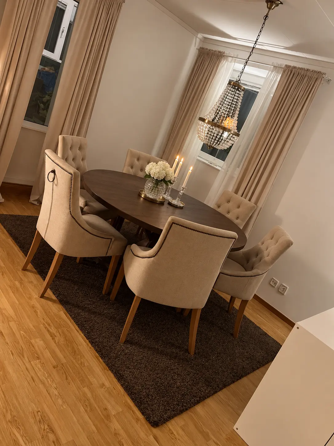 Matplats med runt bord, stoppade stolar och takkrona